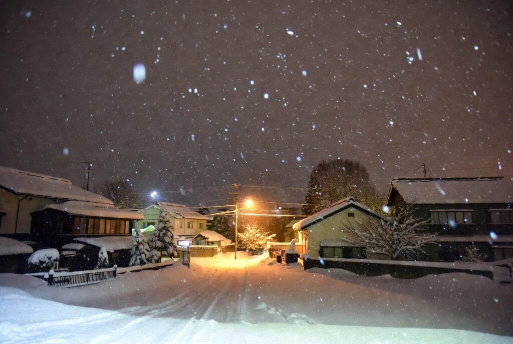 の積雪期における札幌の夜道と街灯のリアルな風景